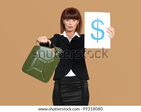 portrait of a young businesswoman, holding a gas canister and a dollar sign in her hands, on beige background