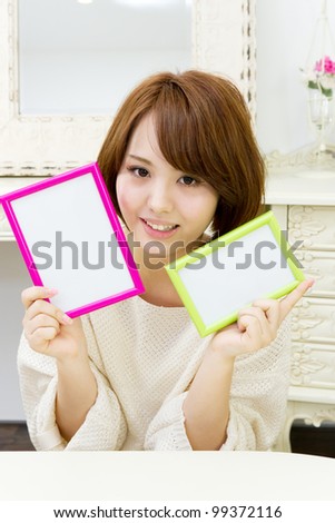 Beautiful young woman with message board