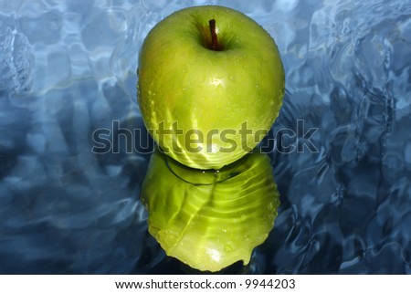 Green apple on water
