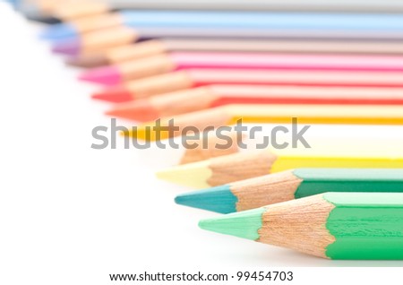 Close up of color pencils in line on white background