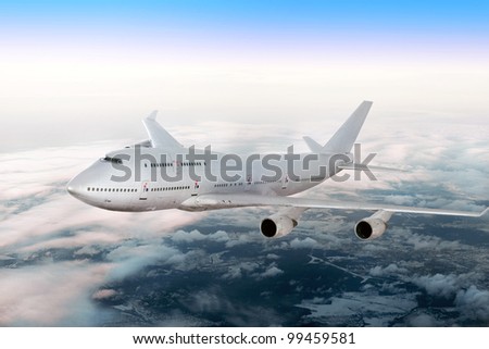 Modern airplane  over the clouds. Royalty-Free Stock Photo #99459581