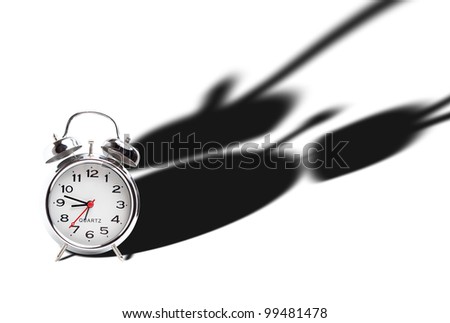 view of alarm clock with dramatic shadow