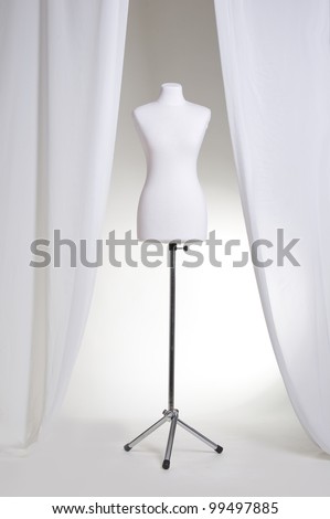 Clothing mannequin white on a light background near the curtains