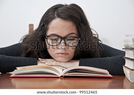 Student girl sleeping photographed with books, white background