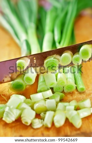 Green Onion catted with knife  on the wooden board