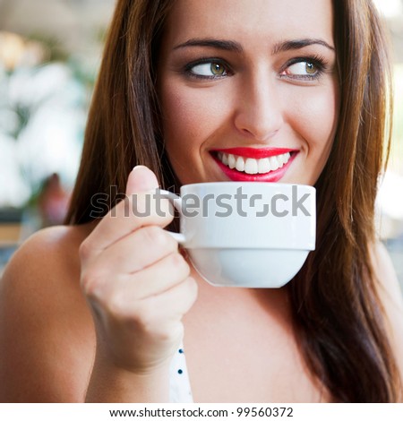 Closeup portrait of a pretty young female having a cup of coffee