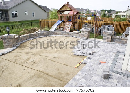 Paving patio on to leveled sand. Backyard Project. Royalty-Free Stock Photo #99575702