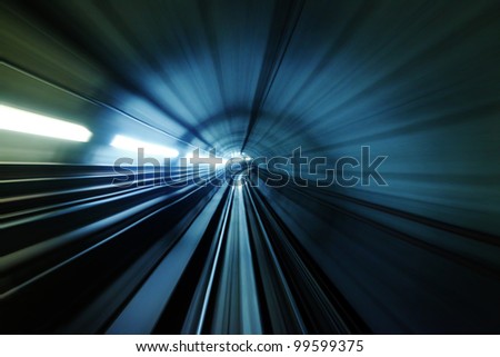 Abstract light trail accelerating through a tunnel. Royalty-Free Stock Photo #99599375