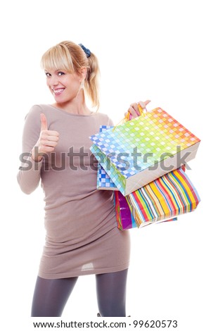 studio picture of woman with bags showing thumbs up. isolated on white