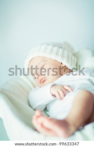 picture of a newborn baby curled up sleeping on a blanket Royalty-Free Stock Photo #99633347