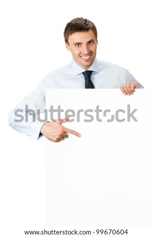Happy smiling young business man showing blank signboard, isolated over white background