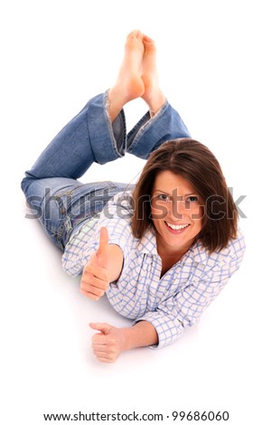 A picture of a young woman lying on the floor and smiling over white background
