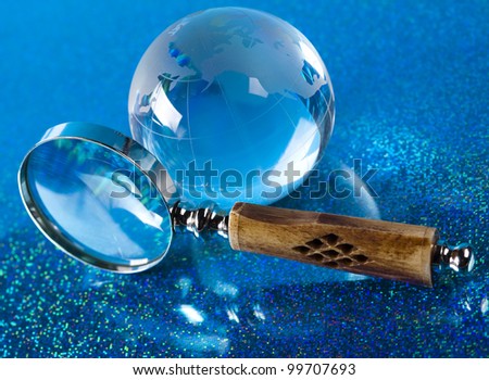 Magnifying glass and globe