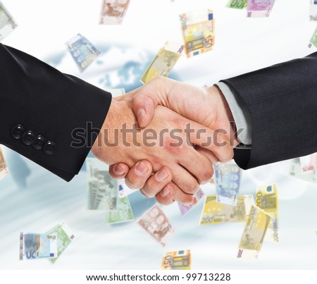 Businessmen shaking hands against a rain of money