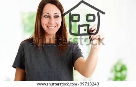 Woman drawing an house on the screen