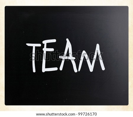 The word "TEAM" handwritten with white chalk on a blackboard