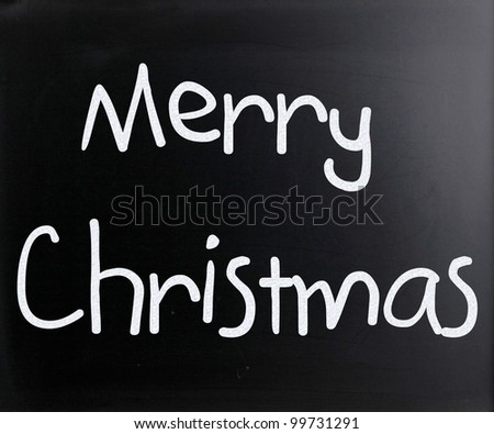"Merry Christmas" handwritten with white chalk on a blackboard