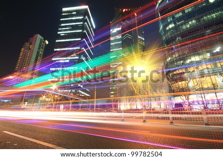 Modern office building rainbow ray background night in Shanghai