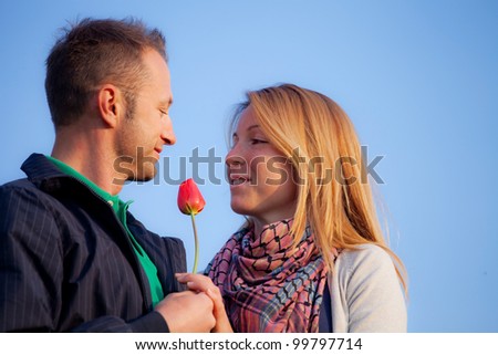 young romantic couple with a flower
