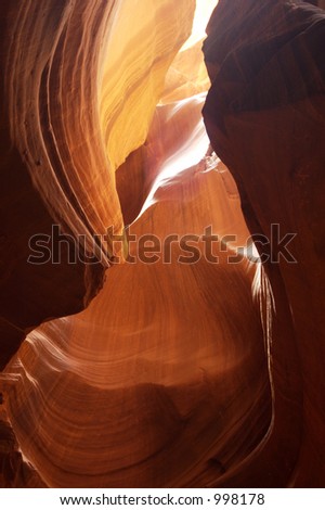 Light reflects from the sandstone walls of a slot canyon in Arizona.