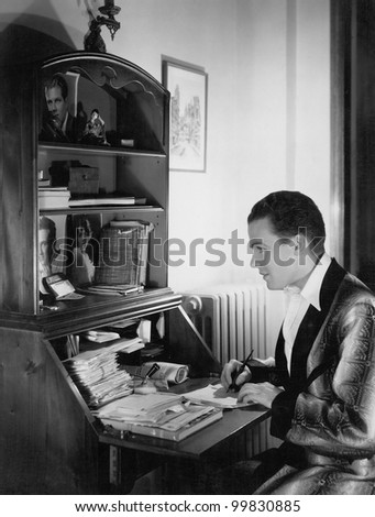 Man writing letter at desk
