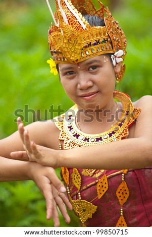 Young Balinese female dancer performing traditional Legong dance