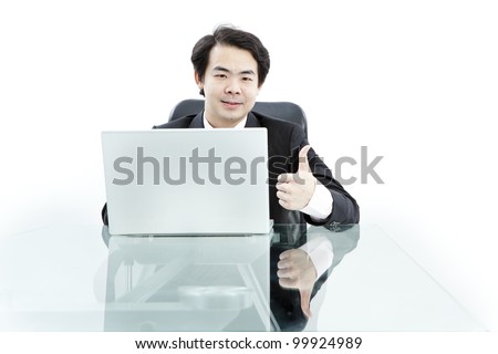 Portrait of handsome young business man using computer