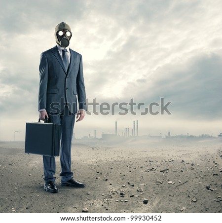 pollution concept: portrait of businessman in a gas mask  with suitcase Royalty-Free Stock Photo #99930452