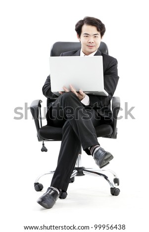 Portrait of handsome young business man using new laptop