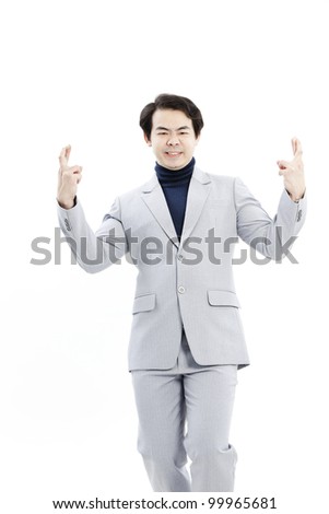Superstitious - entrepreneur with crossed fingers over white background