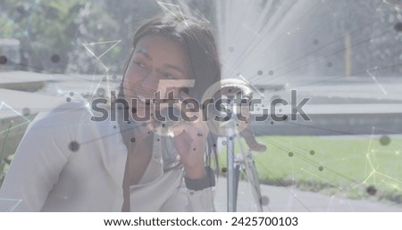 Image of 5g text with network of connections and spots over woman using smartphone in city. digital interface, connection and communication concept digitally generated image.
