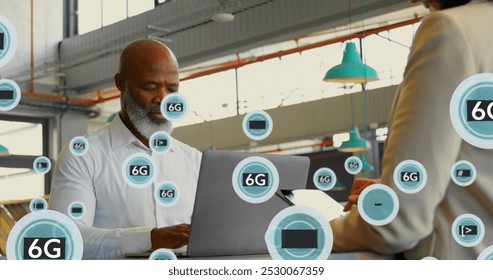 Image of 6g texts and symbols over diverse coworkers using laptop and digital tablet. Digital composite, multiple exposure, signs, telecommunication and technology concept. - Powered by Shutterstock