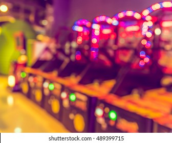Image of abstract blur Arcade game machine shop with bokeh for background usage . (vintage tone)