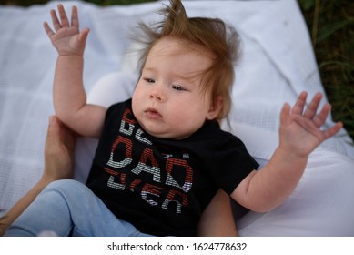 Image Of Adorable Baby Girl Sitting On Grass Making Funny Face, Shallow Depth Of Field