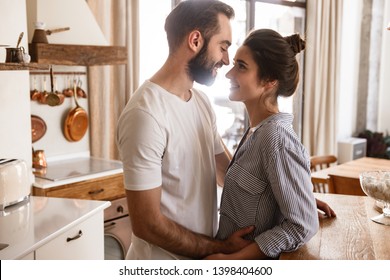 Image Of Adorable Brunette Couple In Love Man And Woman 20s Smiling While Hugging Together In Apartment