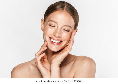 Image of adorable half-naked woman smiling at camera with eyes closed and touching her face isolated over white background