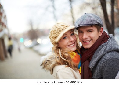 Image of affectionate couple looking at camera in park