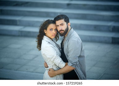 Image of affectionate dates embracing outside
