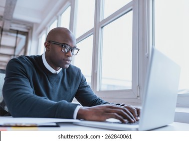 Image of african american businessman working on his laptop. Handsome young man at his desk. - Shutterstock ID 262840061
