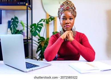 Image Of African American Woman With Turban Over Head Using Laptop In Office