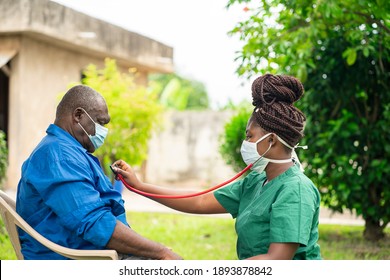 image of african man with face mask, braided black woman in face mask  holding stethoscope- home health care concept