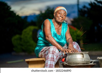 Image Of African Woman, Sitting Besides Cooking Pot