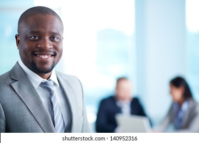 Image Of African-American Business Leader Looking At Camera In Working Environment