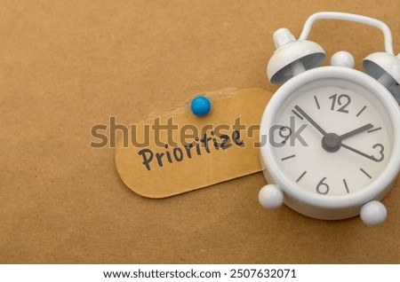 The image of an alarm clock and a note labeled 