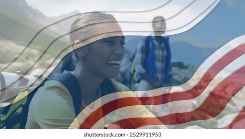 Image of american flag over african american couple smiling in mountains. patriotism and celebration concept digitally generated image. - Powered by Shutterstock