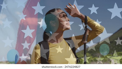 Image of american flag over biracial woman looking away in mountains. patriotism and celebration concept digitally generated image. - Powered by Shutterstock