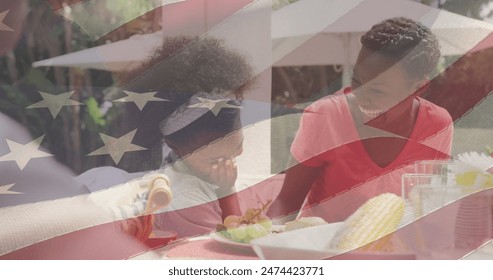 Image of american flag over happy african american family having dinner and smiling. patriotism and celebration concept digitally generated image. - Powered by Shutterstock