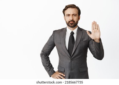 Image of angry boss, raising hand objection gesture. Denying something, saying no and tell to stop, standing over white background - Shutterstock ID 2185667735