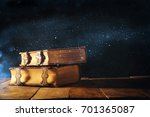 Image of antique books, with brass clasps on old wooden table. fantasy medieval period and religious concept