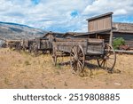 Image of antique horse drawn wagons and historic buildings from the old west, wyoming, USA